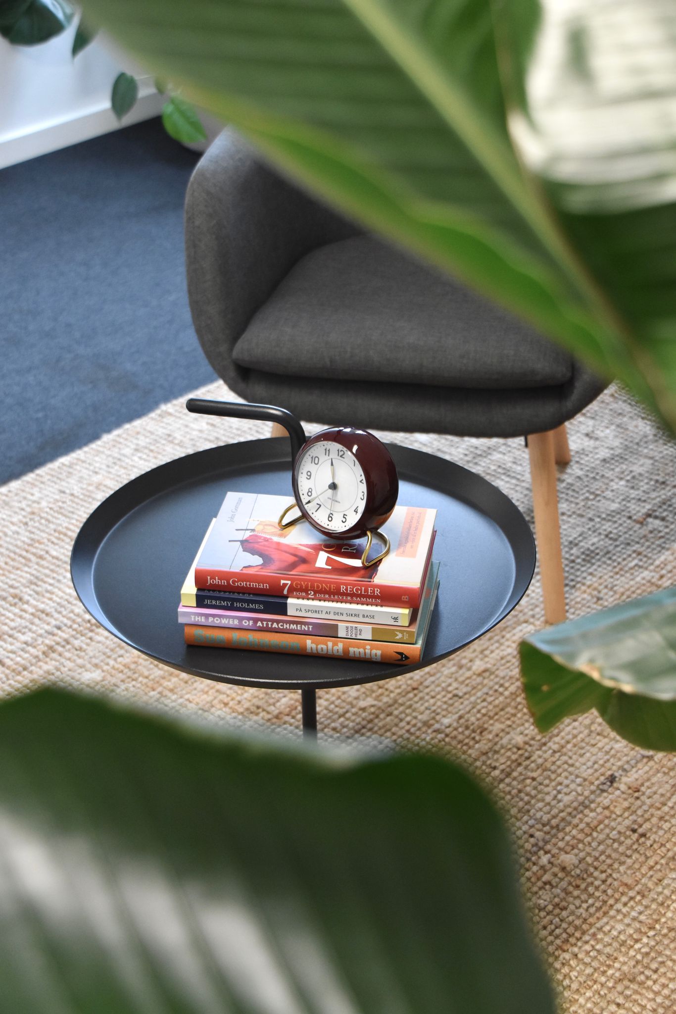 Detalje fra bord med bøger og ur - indbydende og fordybende miljø